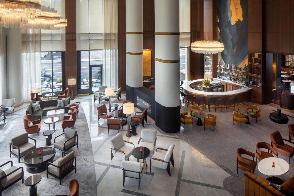 Blue Aster restaurant and spiral staircase lobby at Conrad Nashville