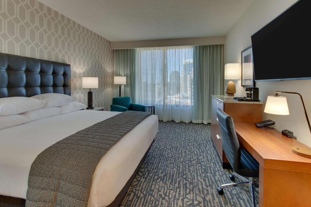 Spacious guest room and suite with microwave and fridge at Drury Plaza Nashville Downtown